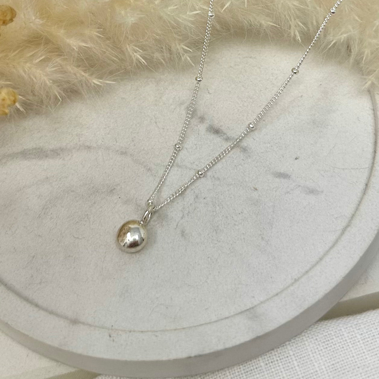 Pebble pendant with satellite chain