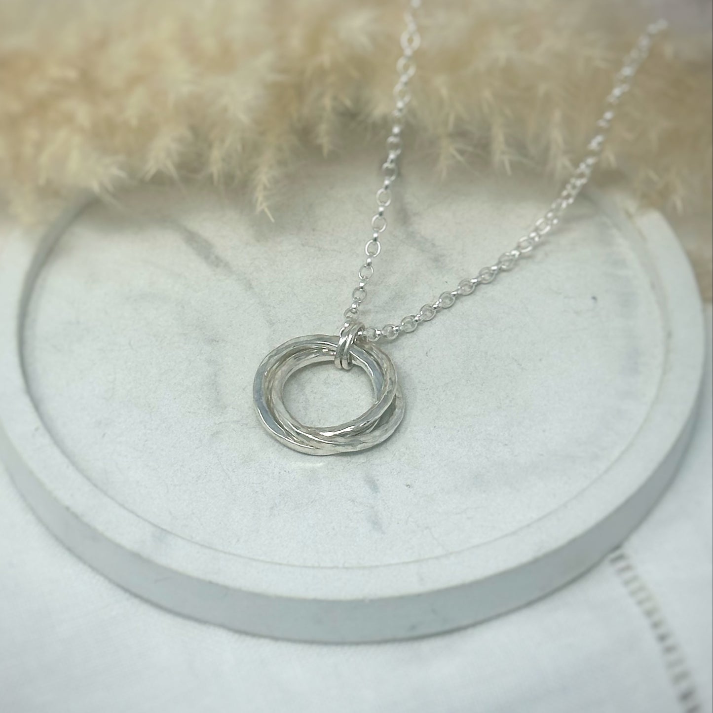 Handmade sterling silver Russian Wedding Ring necklace featuring three interlocking, hand-hammered rings on a 24" belcher chain. 