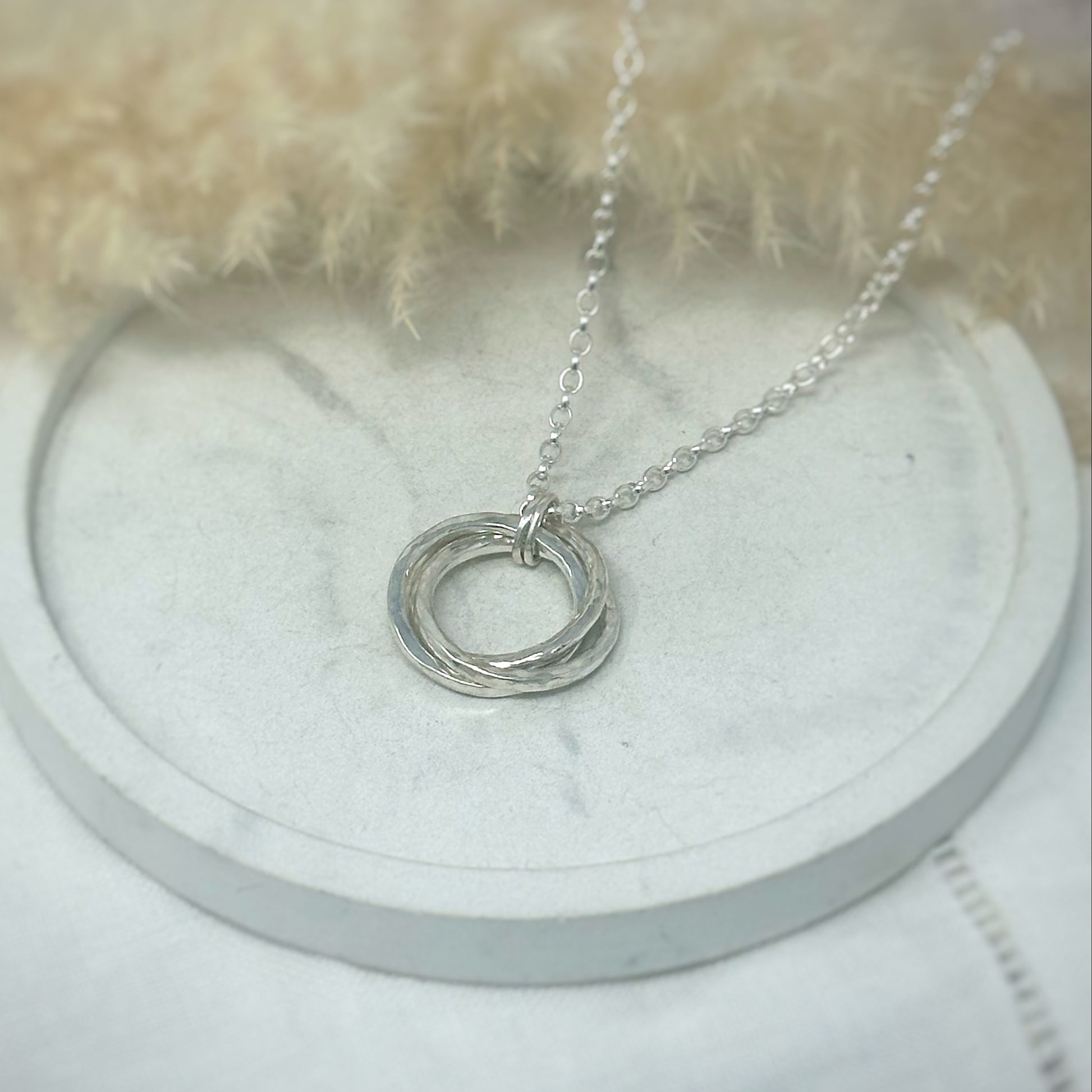 Handmade sterling silver Russian Wedding Ring necklace featuring three interlocking, hand-hammered rings on a 24" belcher chain. 